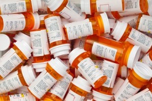 NOTE TO INSPECTOR:  the commercial and personal identifying info has been reomved on all labels Dozens of prescription medicine bottles in a jumble. This collection of pill bottles is symbolic of the many medications senior adults and chronically ill people take.